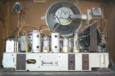 This 1950's radio is built in a wooden case and uses valves and a metal chassis